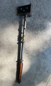 Scepter topped with pie sculpture made from welded steel with leather handle.