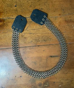 Chainmail guitar strap with leather ends.